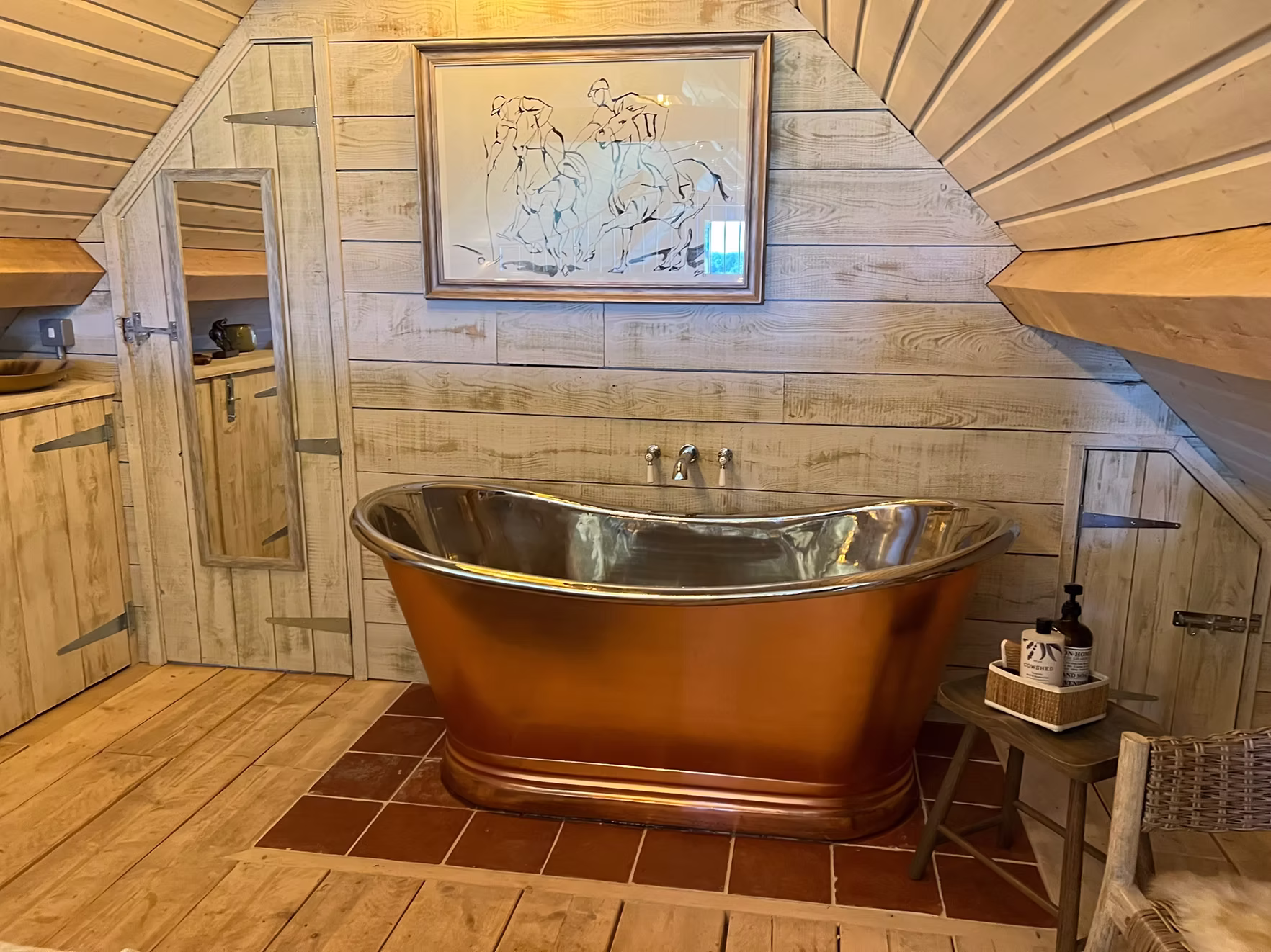 Copper soaking tub in the bedroom suite at The Hayloft, Cotswolds