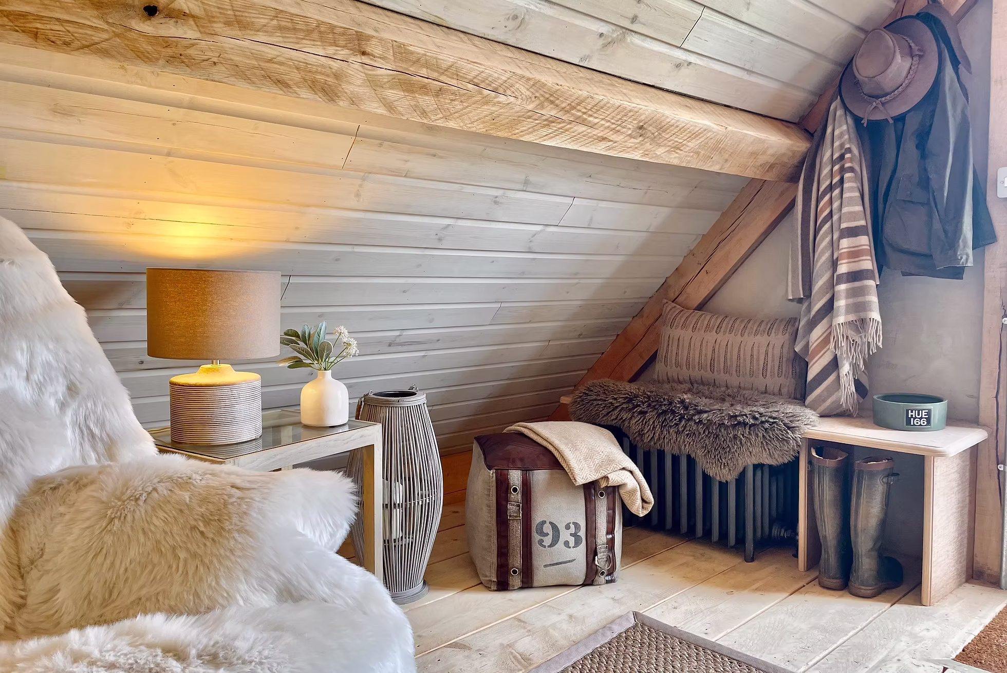 A snug living nook with sheepskins and lamplight